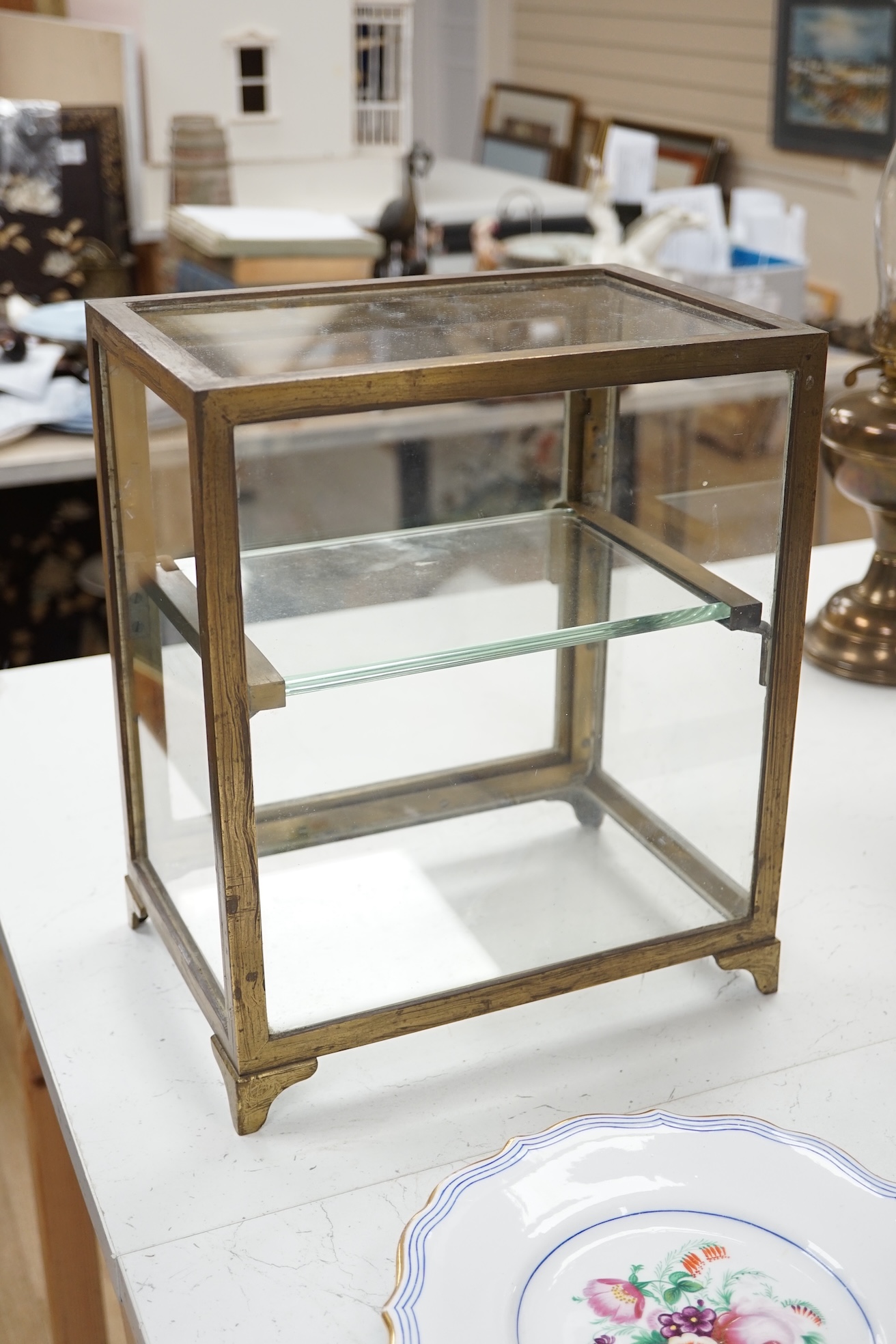 A small late 19th century brass display case, with glass shelf, bears plaque 'J Weiss & Son, 287 Oxford Street, London